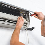 Anderson-Air-of-Franklin-tn-mini-split-installation-thumbnail-close-up-view-of-adult-repairman-repairing-air-conditioner